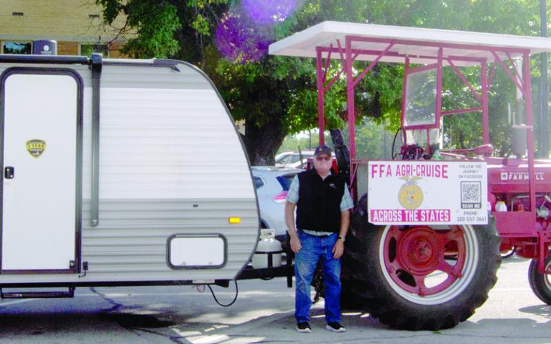 Traveling from Canada to Mexico on a 1940 Farmall M tractor Mark Koehn stopped briefly in Columbus. This marks the halfway point in his 2,000 mile trip.