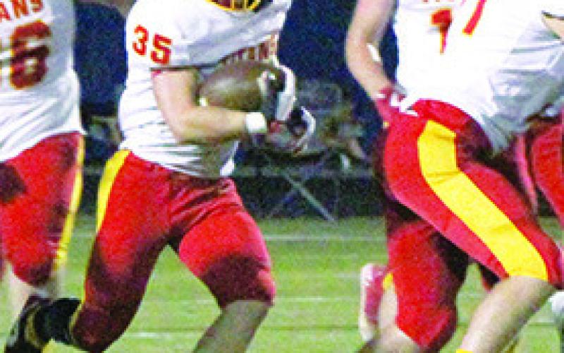 Titan Senior, Syler Schuberger, runs behind a block by senior, Kyler Rahmeier, as he racks up yardage in the 36-0, Columbus win, Friday in Riverton. Syler ran for 53 yards and a touchdown and had two catches for ten yards and a touchdown in the win.