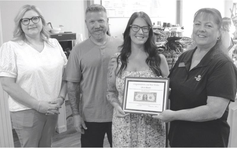 The “First Dollar” plaque was presented to Jennifer Reid, florist and Nate and Casey Long, owners of Life in Bloom and Co. by Sonja Duley at the recent ribbon cutting and open house held Friday. Life in Bloom and Co. sells fresh cut flowers, live plants and gift items. They also feature a coffee bar offering a variety of specialty drinks.