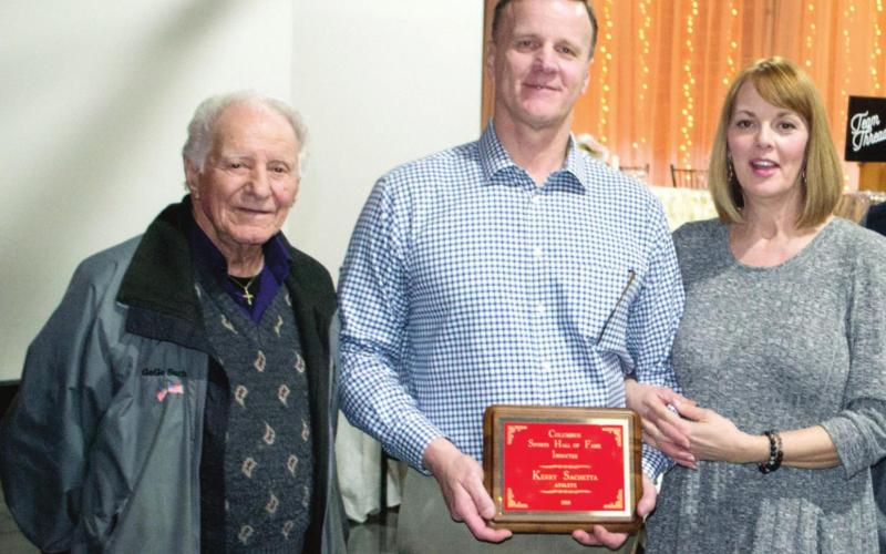 Dr. Kerry Sachetta (center) has been named Superintendent of Schools in the Joplin, Mo., school district. In 2018 he was inducted into the Columbus Sports Hall of Fame. He was joined by his father GeGe Sachetta and his wife Amber.