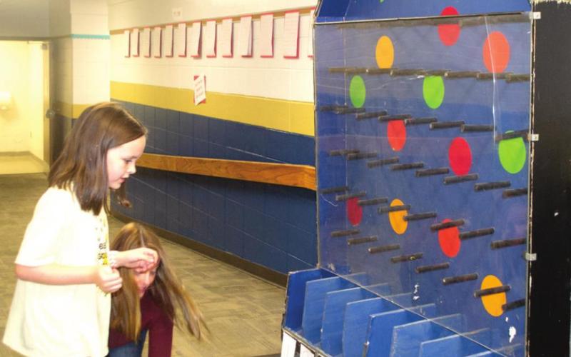 Riverton Elementary Student Hadley Holmes plays Plinko at Riverton School District’s PTO Carnival on Saturday. Numbers along the bottom of the attraction dictated how many pieces of candy she and her peers would be awarded with. Photo by Jacob Spencer