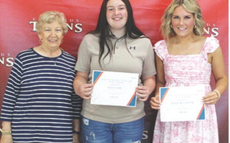 Kadi Cobb and Kenadie Carter received the Mercy Hospital Auxiliary Scholarship in the amount of $300 each from Lucille McNemar during the 2025 Senior Assembly, May 16, at the Columbus Unified High School Gymnasium.