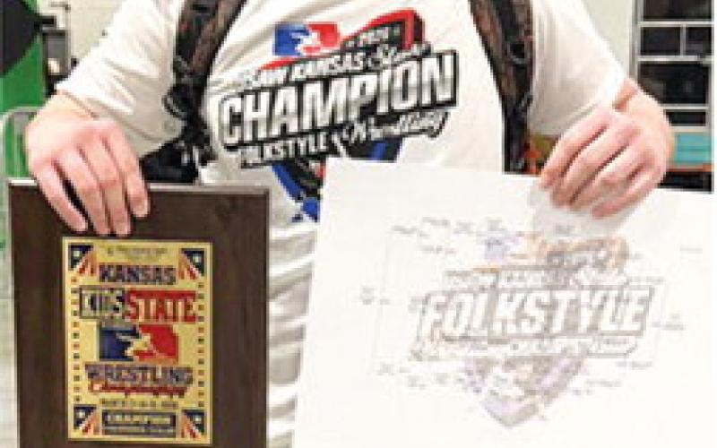Columbus Wrestling Club’s 2026 USAWKS State 14U 235 Folkstyle Wrestling Champion, Cajen Smith, displays the plaque and bracket he earned at the tournament in Topeka, Saturday. Courtesy photo.