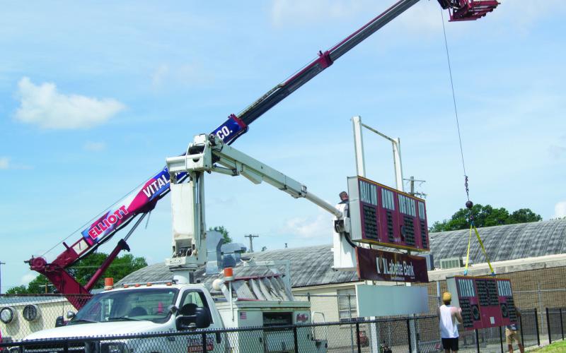 After more than 30 years, the Columbus High School football scoreboard has been removed from the south end of the stadium. If the scoreboard could talk, the stories it could tell. It will be replaced this summer and next year the Titans will be playing before a new modern scoreboard. Vital Signs is handling the sign replacement.