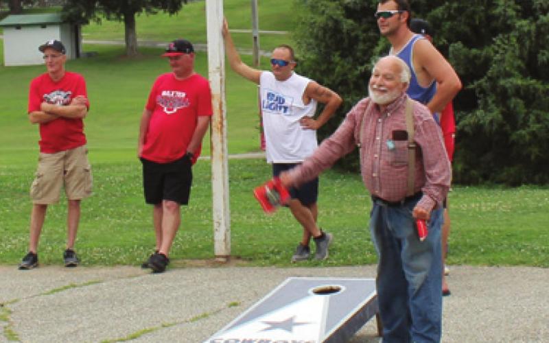 American Legion member Bill Martins takes a turn tossing bags as some the competitors became spectators after Saturdays cornhole Tournament in Baxter Springs. Photo by Dee Riley.