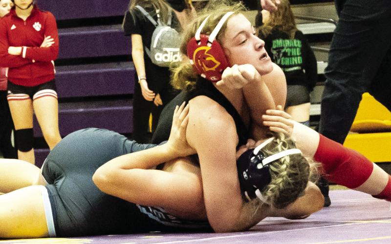 Lady Titan Senior, Addison Saporito, works for one of her four pins in the Kansas Class 4-3-2-1A Regional Championship Tournament, Saturday in Coffeyville. Addison claimed the 120-pound Regional Champion Title and advances to the state tournament, February 22-23, in Salina. Courtesy Photo.
