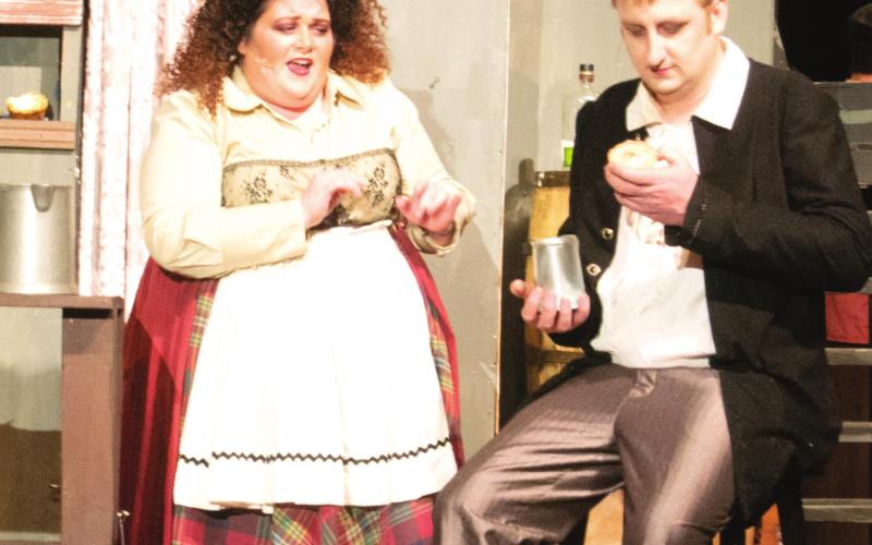 Cherokee County Arts’ latest musical, “Sweeney Todd,” is running tonight and tomorrow night at 7:30 in the James R. Christman Performing Arts Center in Galena High School. The title character, Sweeney Todd (Chris Tanksley), admires one of Mrs. Lovett’s (Kimberly Arzoian) famous meat pies early in the first act. Photo by Jacob Spencer.