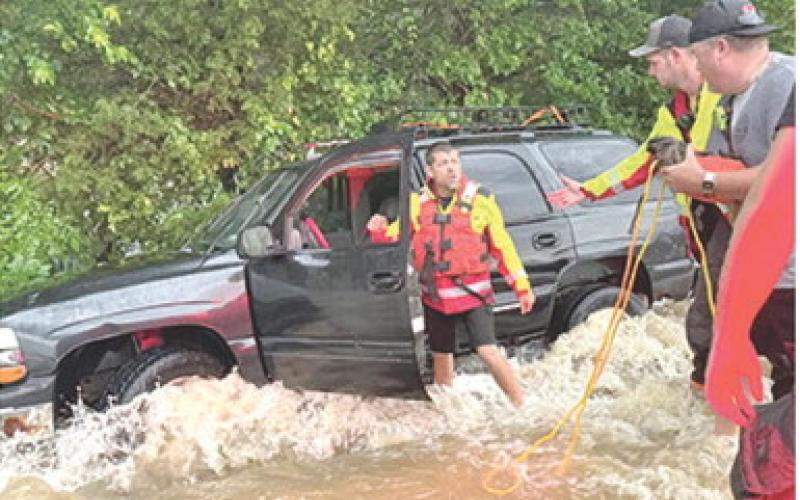 Emergency personnel were busy late Sunday night and early Monday morning performing water rescues of people who had driven into high water. Cody Burton, Dylan Koehler and Korey Lucian were among the firefighters from Columbus. Photo courtesy Columbus Fire Department.