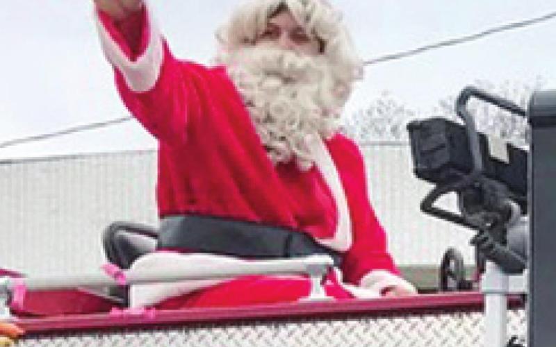 Santa made an appearance in the Baxter Springs Chamber of Commerce Christmas Parade. Riding atop the Baxter Springs fire truck, he tossed candy to the youngsters and greeted the crowd.