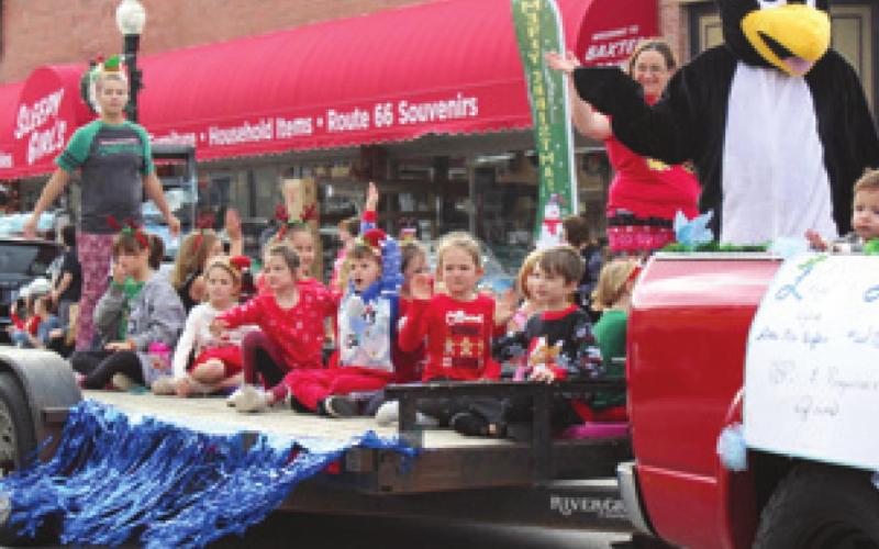 Members of the Penquins cheer team rode along the parade route on their float.