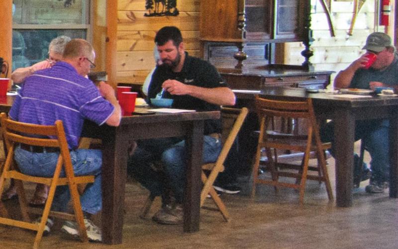 Representatives from Columbus-based community businesses and organizations met at Rowdy’s Rustic Moose Lodge for their monthly Chamber meeting. Dale Helwig from the K-State Research and Extension Office, Mike Evans from Liberty Utilities and David Holmes from Torchia-Holmes Real Estate all enjoyed a lunch prior to the meeting beginning. Photo by Jacob Spencer.