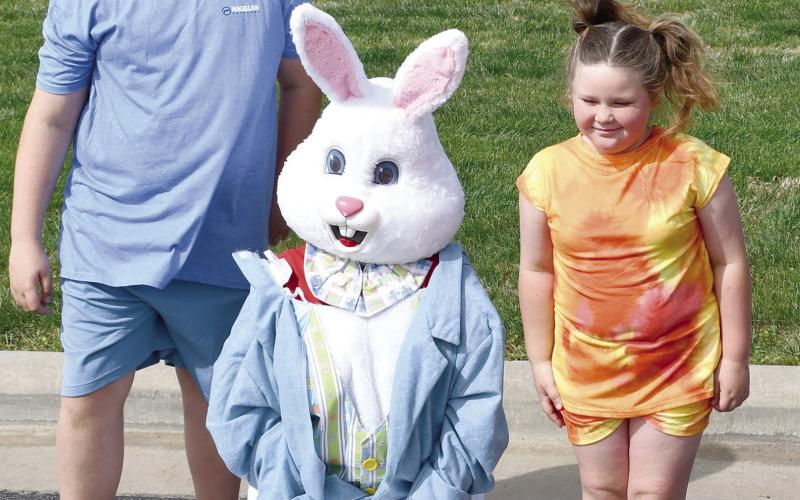 Visiting with the Easter Bunny Corbin and Chole Lake were among the hundreds of youngsters at the Baxter Springs High School. The hunt is sponsored by the Baxter Springs Kiwanis Club. The event was held Saturday at the Junior High and High School complex. Photo by Greg Hiatt.