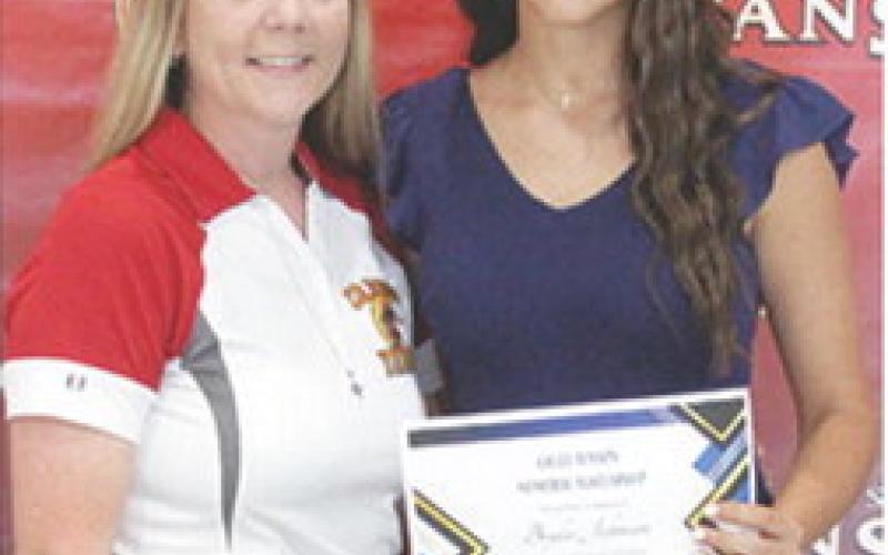 Brylie Johnson received the Callie Henson Memorial Scholarship in the amount of $500 from Ryan Lacen during the 2025 Senior Assembly at the CUHS Gymnasium, May 16.