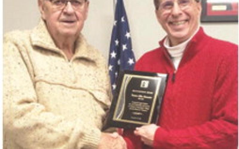 Dr. Mark Watkins, the President of Labette Community College (LCC), presented an appreciation plaque to Mike Howerter for his years of service and leadership to LCC and the Board of Trustees. Howerter served as a LCC Board of Trustees member from 2015 to 2024. Courtesy photo.