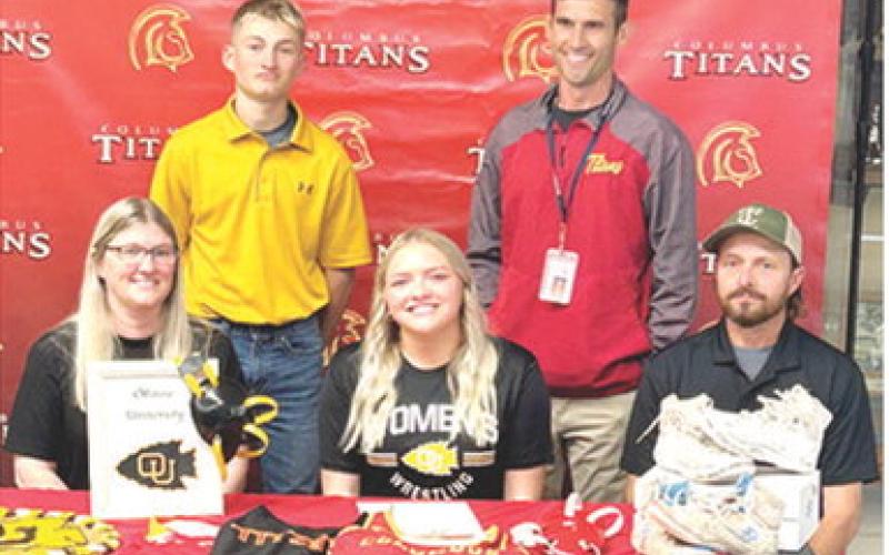 Lady Titan Senior, Emily Britt, signed a National Letter of Intent to continue her wrestling career with the Ottawa Lady Braves this fall. Emily was joined by her parents, Kimberly and Carl Britt and brother Carlson and Titan Head Wrestling Coach Marcus Bowman at her signing ceremony, Wednesday, at the Columbus Unified High School Gymnasium. Courtesy photo.