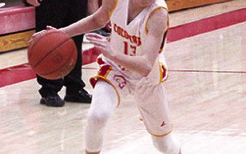 Titan Eighth Grader, Carter Woodcock, drives to the basket in games with Baxter Springs, in January, at the Central School Gymnasium.