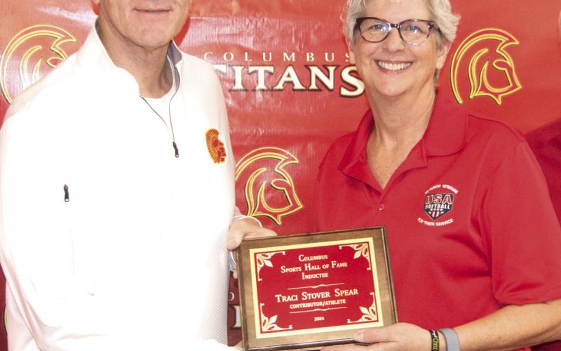 Presenting the plaque to inductee Traci Stover Spear, was Columbus Hall of Fame chairman Kerry Sachetta.