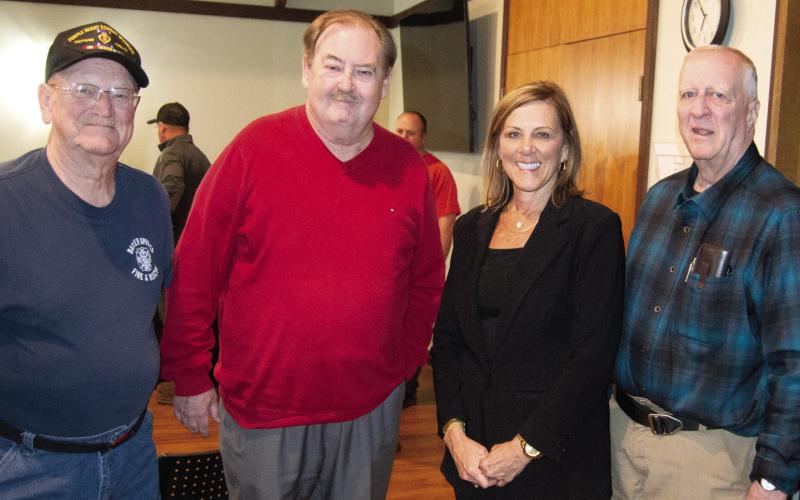 Two long time fire fighters (left) Wayne Cook and Les Page surround Tim Shallenbuger and City Treasurer DeeAnn Auman-Hill. Shallenburger and Hill worked tirelessly on procuring the funding for the new building.