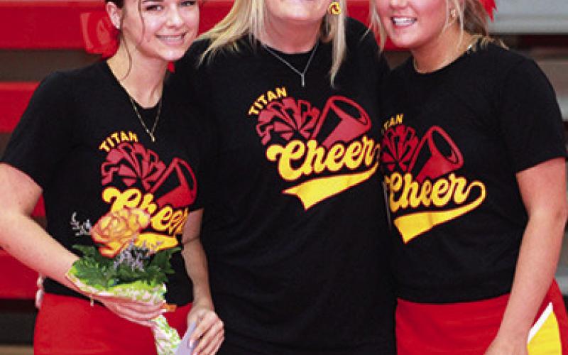 Lady Titan Seniors, Allison Burns and Kenadie Carter were recognized during Senior Night Ceremonies at the wresting dual with Labette County, Monday. Both are members of the Wrestling Cheer Squad and are shown with their sponsor, Amanda Stone.