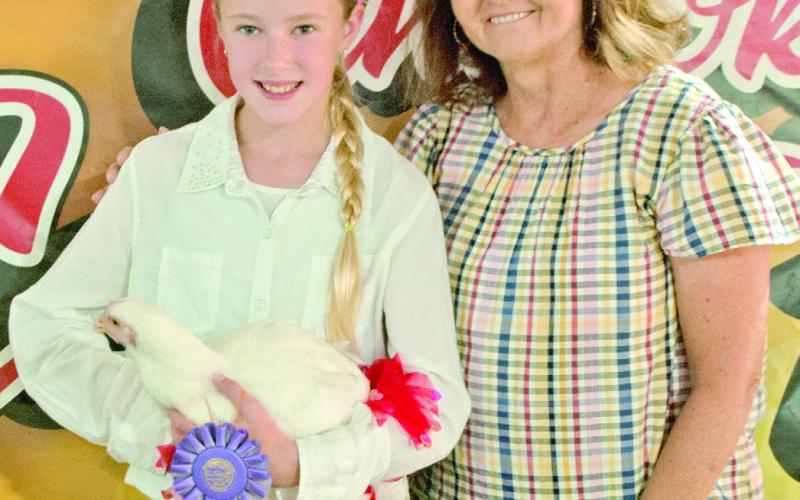 Lone Elm Beaver’s member Cheyenne Gavin showed her grand champion chicken in the poultry competition. The fowl received a bid of $850 from Labette Bank. Donna Westervelt represented the bank at the sale.
