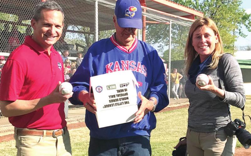 Jeff Idelson and Jean Fruth were presented with signed baseballs from the Baxter Springs Little League during opening ceremonies at the newly renamed Wayne Metcalf Field. Jeff and Jean are working on a book celebrating the Grassroots of Baseball along Route 66. They are shown above with field namesake, Wayne Metcalf. Photo by Dee Riley.