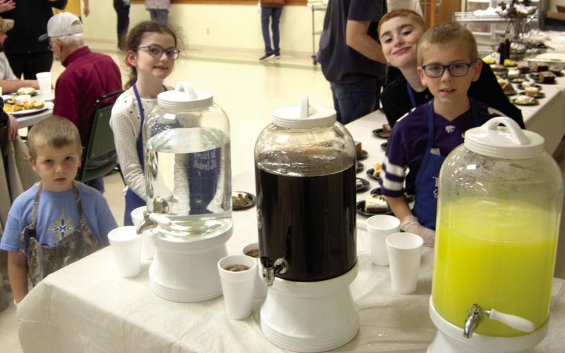 All hands are on deck when serving the annual Knights of Columbus Fish Fry in Scammon. Even the youngsters volunteer to help. Andrew Holden, Zoe Friemel, Zane Friemel and Jacob Friemel assisted at the beverage table.