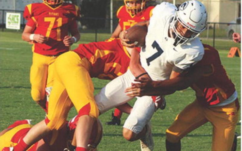 The Titan Defense including Kai Langerot and Brody Carter, sophomores, work to bring down Galena’s freshman quarterback, Dredon Watson, during the junior varsity match-up with the Galena Bulldogs, Monday. Galena came away with the shut out win, 24-0.