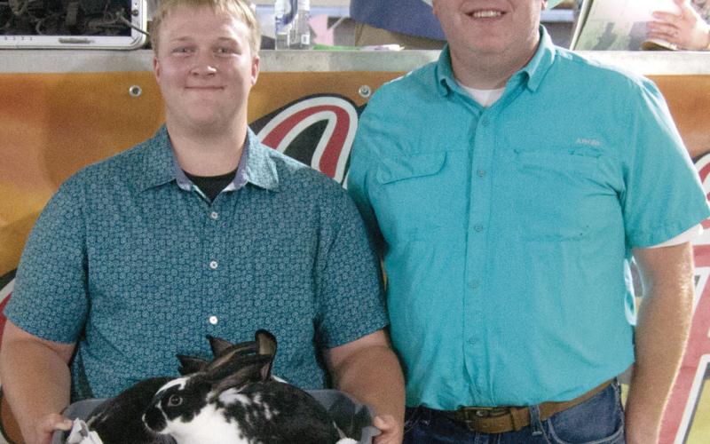 Glittering Stones 4-H member Joshua Brown, son of David and Serena Brown, showed the Grand Champion Rabbit colony and received a premium of $2,000 from Rainbow Solar.