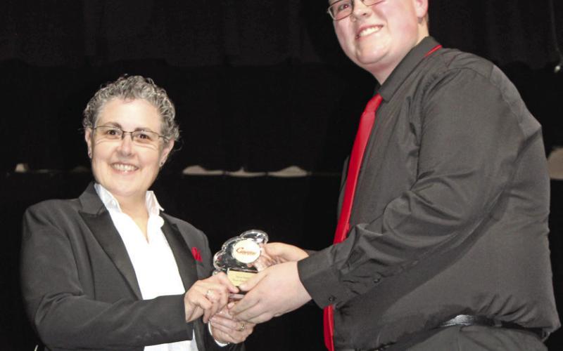 Isaac Johnson (right) was the recipient of the Most Improved Award. His award was presented by Gae Phillips, band director during the Spring Concert May 4.