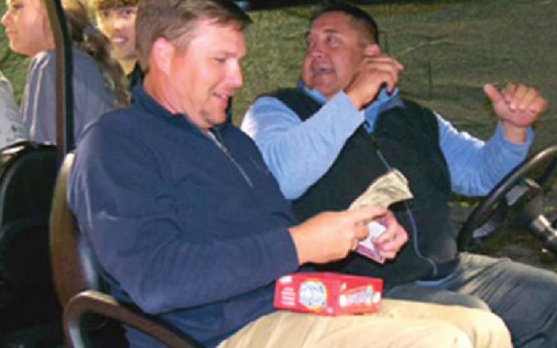 Above: Hannah Kelley tries her luck at Blackjack during Baxter Springs High School’s After Prom event. Kelley just won another hand. Larry Warner, grandfather of one of the BHS seniors acted as dealer for the night. Left: Superintendent David Pendergraft (in driver’s seat) and School Board President Dusty Deringer hosted Cash Cab. Students (in back) Noah Kemp and Maggie Pendergraft answered trivia questions to win cash. Photos by Dee Riley.