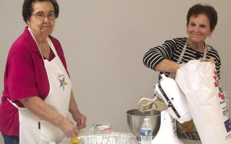 Each of the Mercy Auxiliary members had a task when they recently gathered to make noodles for a fundraiser. Ladonna Smith was rolling dough and Ann Thiele was measuring flour. Columbus News Report photo by Shawn Churchill.