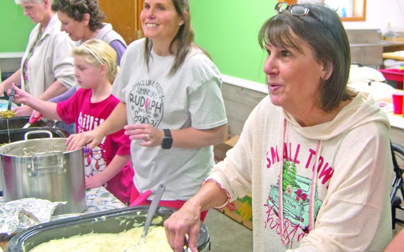 Volunteers were all smiles as they served the Community Christmas dinner Saturday afternoon. Diners were treated to turkey with all the fixings as they visited with friends old and new.