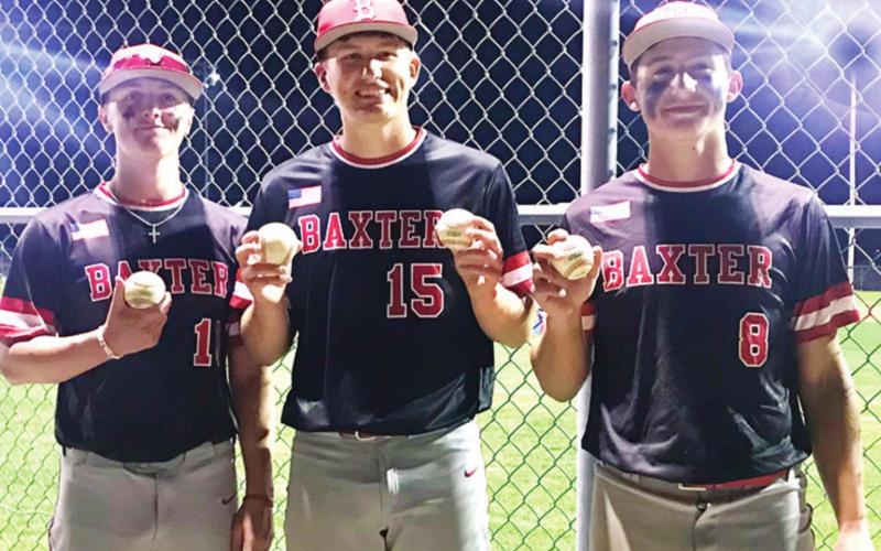 Baxter Springs Lions hitters, Kameron Williamson, Riley Bush and Kaden Niday display their home run balls, a grand slam for Niday, as the Lions clinch the CNC League Title with a sweep of the Bulldogs, 22-5 and 11-3, in Galena, Thursday Night. Photo by Dee Riley.