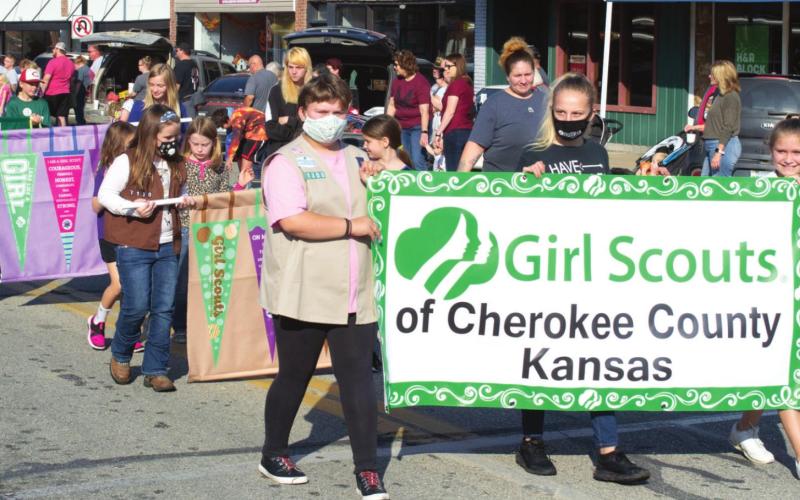 Cherokee County Girl Scouts marched in the Columbus Day Parade last year. Girl Scouts are active in numerous community service projects and help out in many activities.