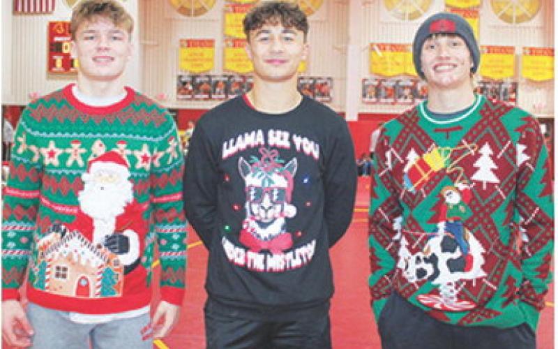 The Titans didn’t win the 2025 Columbus Duals Tournament, but they did bring home the title of ugliest sweaters. Modelling their versions of the Christmas novelty are seniors, Dane Merrick, Jayden Rodriguez, and Cal Saporito.