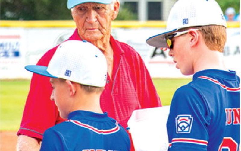 Reigning Kansas Little League Baseball District 2 Administrator, Wayne Metcalf, hands out awards to teams competing in the Kansas State Little League Championship Tournament in Baxter Springs, July 24-25. The Pittsburg JL Hutchinson League All-Stars won the 11-12 year-old division over The JOCO Navy (Royals Amateur Development System) in a close bestof- three series hosted by the Baxter Springs Little League at Wayne Metcalf Field.