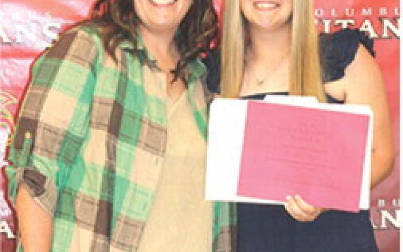 Senior Morgan Richards received the $150 Difference Maker Scholarship from Kerri Matson during the Columbus Unified High School Senior Assembly, in the CUHS Gymnasium, May 15.