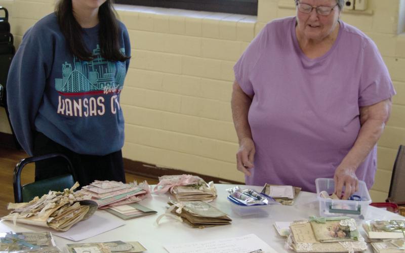 The 13th annual scrap book day at St. Bridgets in Scammon had more than 55 participants. During the session Saturday morning Laryn Keller and her grand mother Marilyn Keller taught a class on book binding the scrap books.