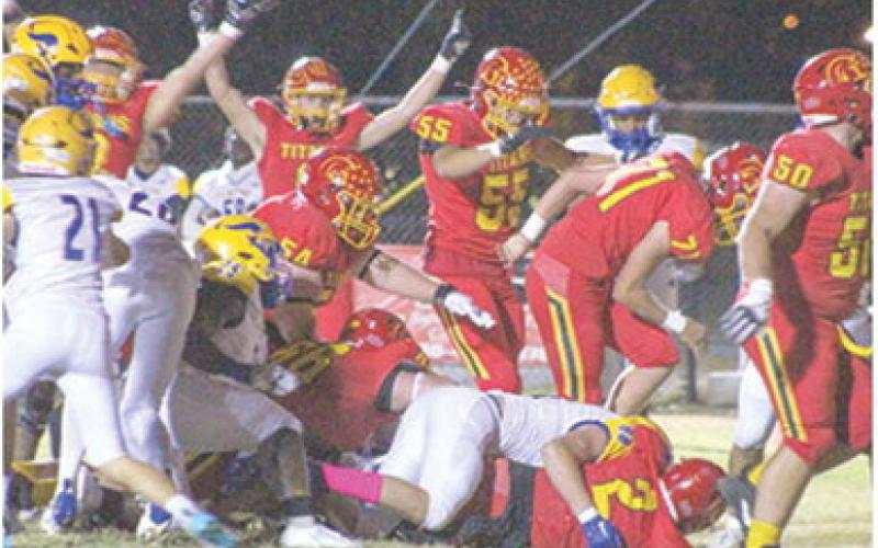 A host of Titans cheer on junior, Jett Tanner as he crossed the goal line from six yards out for the first six points of the 28-21, Columbus win over Parsons, Friday at Titan Stadium.