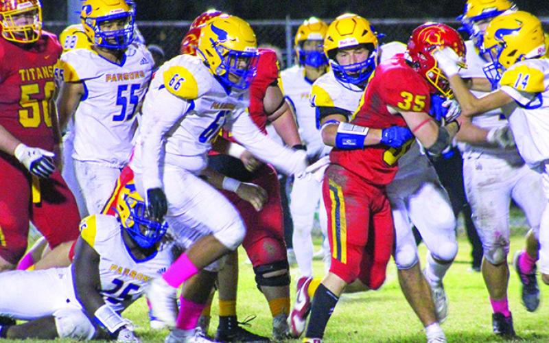 Titan Senior, Syler Schuberger, works against a swarm of Vikings on his was to the end zone for a touchdown in the 28-21, Columbus win over Parsons, Friday night at Titan Stadium. The Titans will host Parsons again, Friday, in the first round of the Kansas Class 3A State Playoffs.