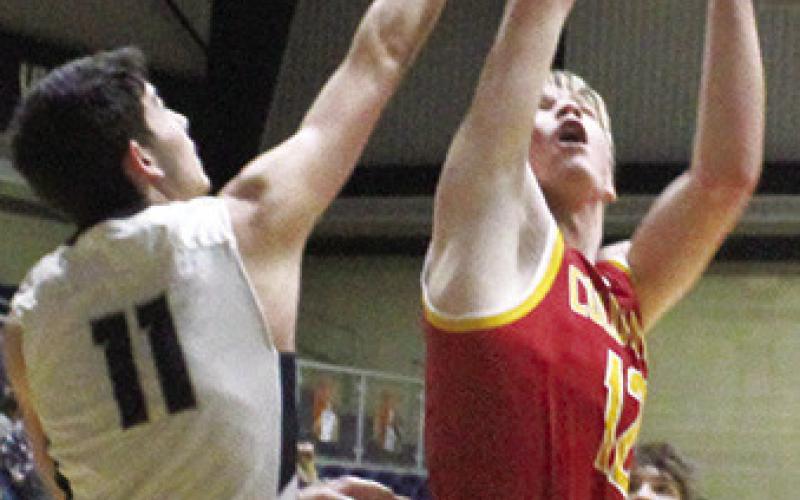 Galena Senior, Hadley Price, fouls Titan Junior, Cole Youngblood, on his shot for a Columbus and-one in the 40-47 loss to the Bulldogs in Galena, Tuesday. Cole led the Titans with 12 points off the bench.