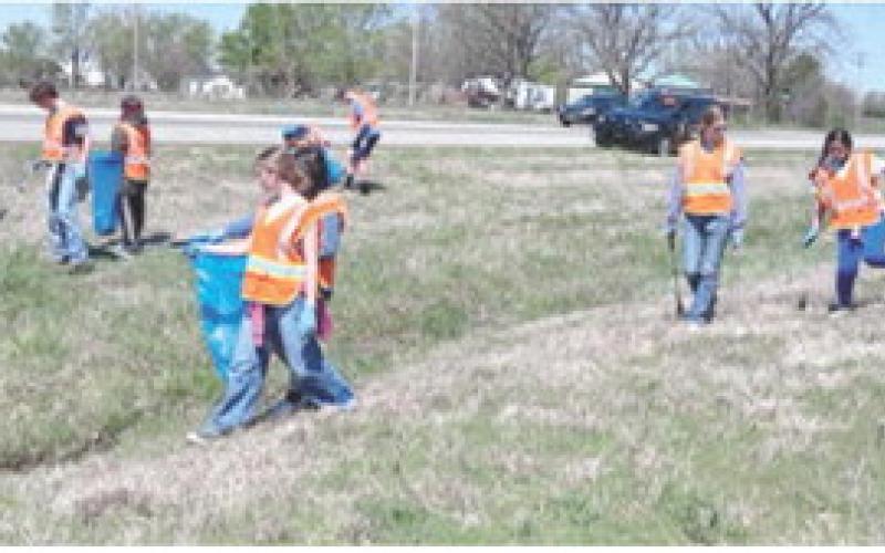 Southeast seventh grade students participated in a day of service April 8. Groups picked up trash along Highway 7 and cleaned headstones in the Cherokee Cemetery and completed other grounds maintenance. Courtesy photo.