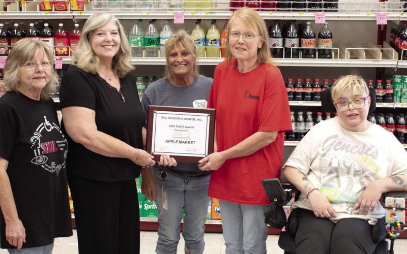 In recognition of their community impact in employing qualified persons with disabilities, SKIL Independent Living Advocate Jeanette Graham, SKIL President and CEO Shari Coatney and Tara Frasier (far right) also a SKIL Independent Living Advocate, present an award to the Columbus Apple Market. Apple Market assistant manager Kristy Jameson and manager Candy Phillips received the award on behalf of the store.