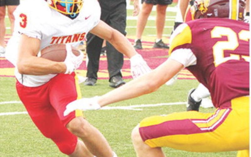 Senior, Jayden Rodriguez, eyes Girard defender, Gavin Huber, in an effort to give him the slip during the Jamboree scrimmage in Girard, Friday. Jayden is one of seven seniors on the Titan Team this season.