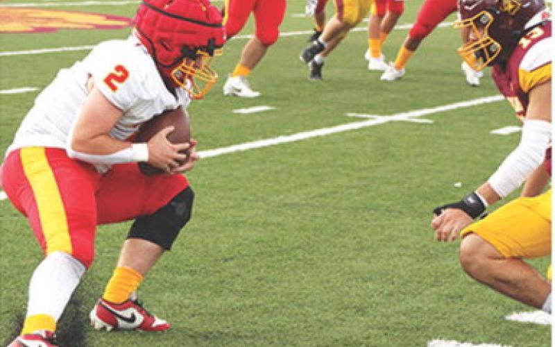 Jett Tanner, Titan Senior, puts on the breaks to out maneuver Girard Senior, Adam Basauri, during the opening plays of the four-team Jamboree scrimmage hosted by the Trojans, Friday, at Frank Jameson Field.