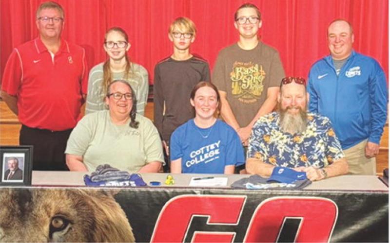 Lady Lion Chloe Hall has signed a National Letter of Intent to play golf at Cottey College as she takes her skills on the links to the next level. Chloe’s golf coach Art Roberts, and siblings Hanna Hall, Jace Hall, and Joseph Hall, and Cottey Coach Dom joined their parents, Amanda Hall, Chloe, and Travis Hall for the signing at the Baxter Springs High School Auditorium following the girls season last October. Courtesy photo.