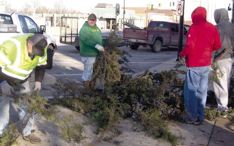 Members of the Columbus Lions Club spent New Years Day afternoon sawing-up and hauling away the Christmas tree which they placed in front of the Courthouse a month earlier. This was the ninth year the Lions Club had placed the tree behind the fountain.