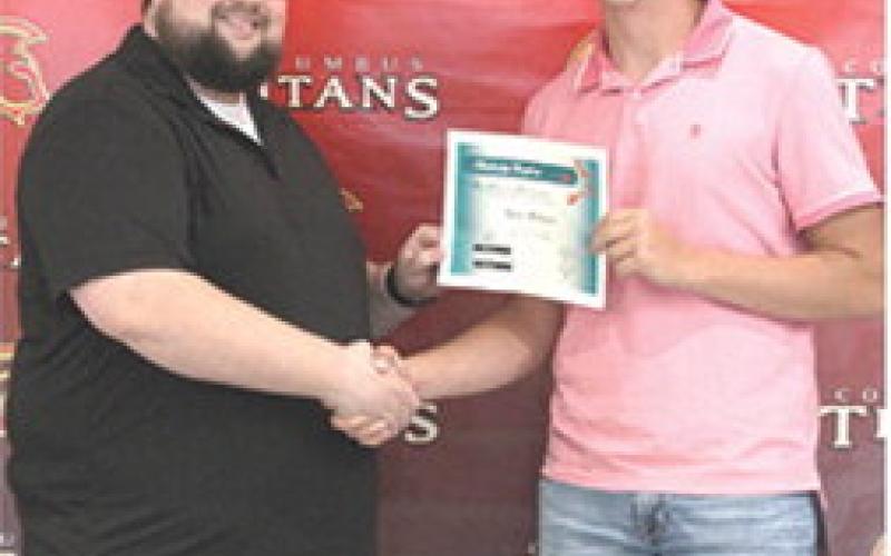 Kyler Rahmeier received the First Christian Church Scholarship in the amount of $500 from FCC Pastor, Cody Bohall, during the 2025 Columbus Unified High School Senior Assembly, May 16, at the CUHS Gymnasium.