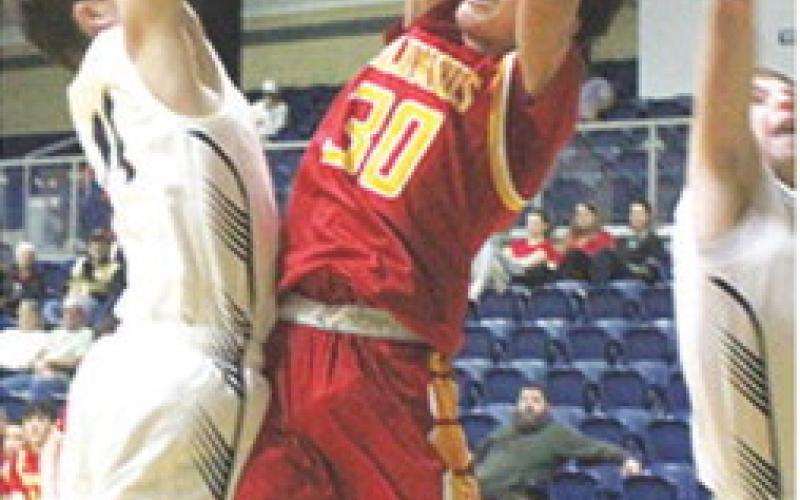 Titan Junior, Drake Laurance, fails to draw a foul against his Galena defenders on his attempted shot in the 29-58 loss to the Bulldogs in Galena, Tuesday.