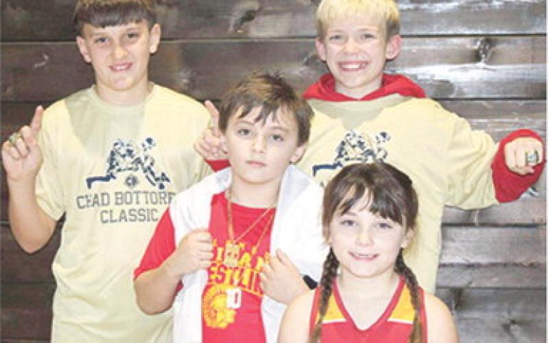 Briggs Johnson, Bearett Bowin, Lucas Natalini, and Jolie Bowin wrestled at the Chad Bottorff Memorial Classic Wrestling Tournament, Saturday, in Springdale, Ark. Jolie placed fourth and all the boys brought home gold rings. Courtesy photo.